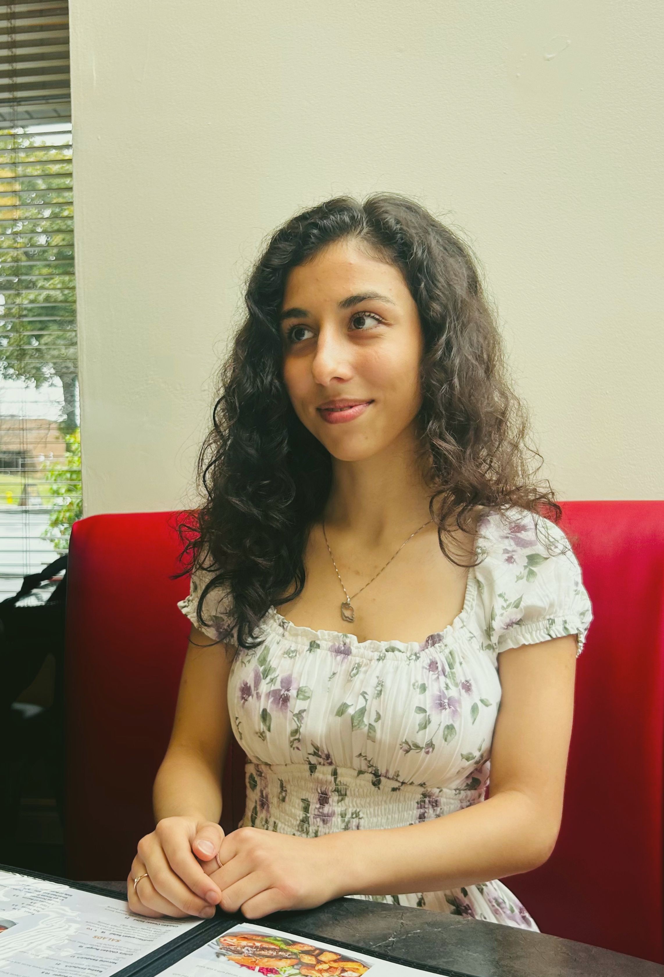 Parnia sipping coffee at a café